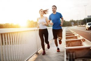couple jogging taking exercise to lower blood pressure